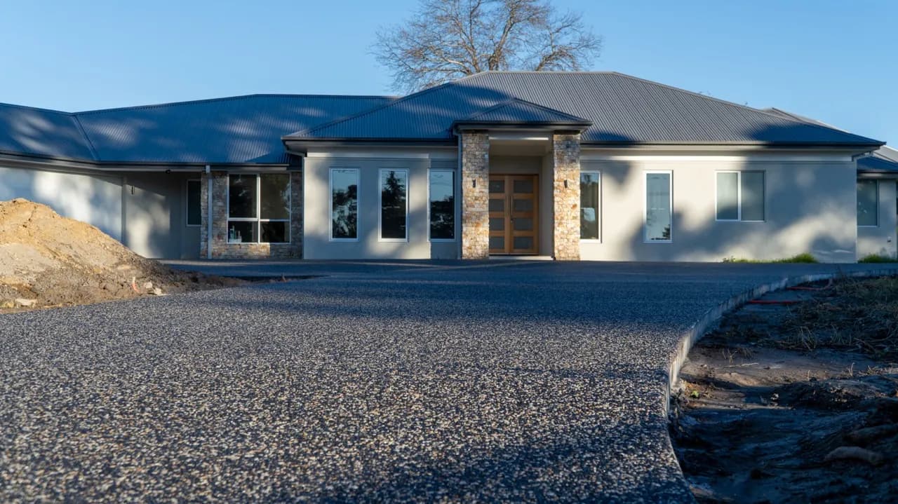 Finished exposed aggregate driveway in front of a modern Melbourne home
