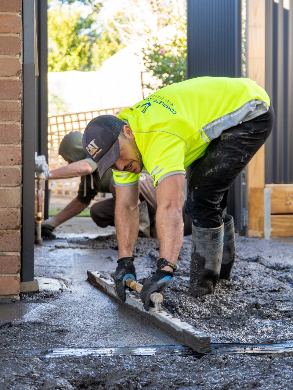Concrete finishing workers leveling cement